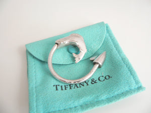 Silver ring with fish design on a Tiffany & Co. branded pouch