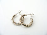 A pair of Tiffany & Co silver 18K gold rope hoop earrings with posts for pierced ears.